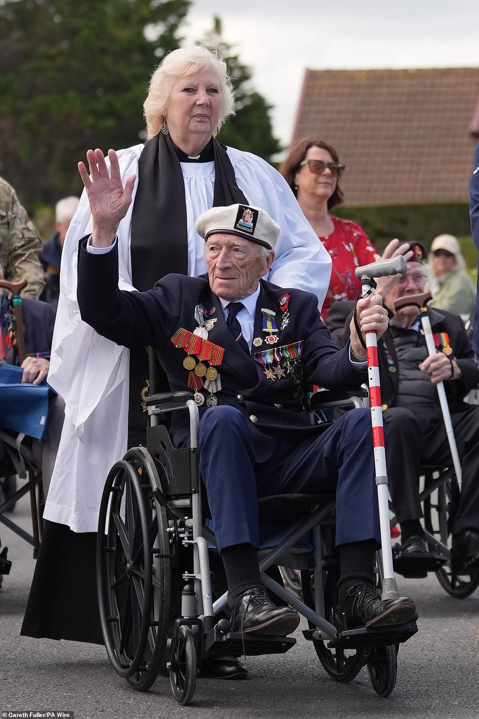 D-Day veteran Alec Penstone, 98, is pushed past crowds at the Spirit of Normandy Trust service