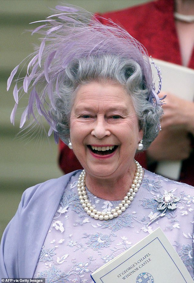 The late Queen Elizabeth wore an embroidered lilac dress and matching feathered fascinator - although the couple advised guests not to wear hats