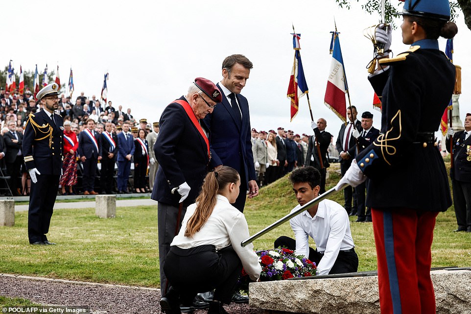 France's President Emmanuel Macron (center R) and Achille Muller (center L), 98, last survivor of the Free French Forces, look on as a wreath is layed during a ceremony commemorating SAS paratroopers and Free French Forces who died