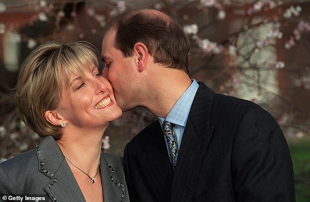 Sophie Rhys-Jones smiles as she is kissed on the cheek by Prince Edward during the announcement of their wedding in January 1999
