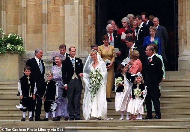 Members of the royal family accompany the newlyweds on the steps of St George's Chapel