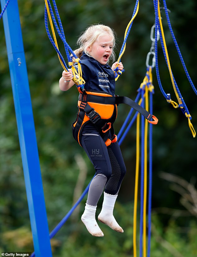 Lena playing on the bungee trampoline at the 2023 British Eventing Festival at Gatcombe Park