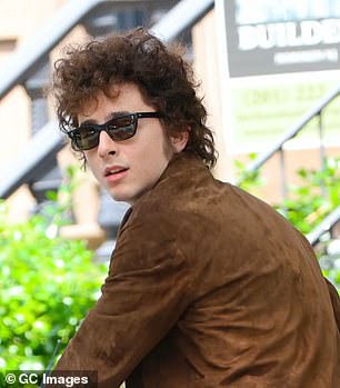 Timothee Chalamet channels Bob Dylan’s 1960s cool with sunglasses and a suede jacket as he and costar Elle Fanning ride a motorcycle on set of biopic A Complete Unknown