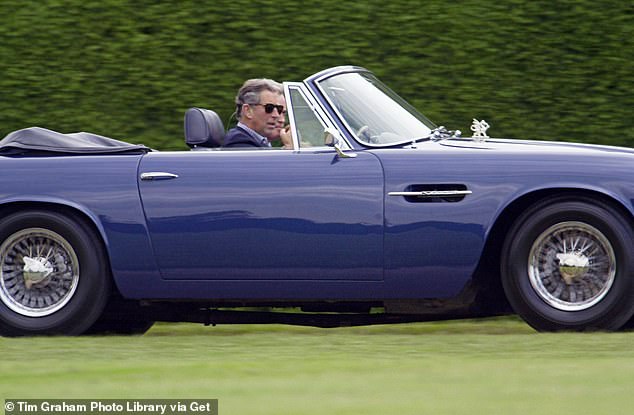 Charles driving his Aston Martin DB5 Volante at Cirencester Park Polo Club in the year 2000