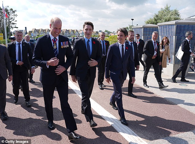 Prince William smiles as he walks alongside Canadian Prime Minister Justin Trudeau and French Prime Minister Gabriel Attal at Juno Beach