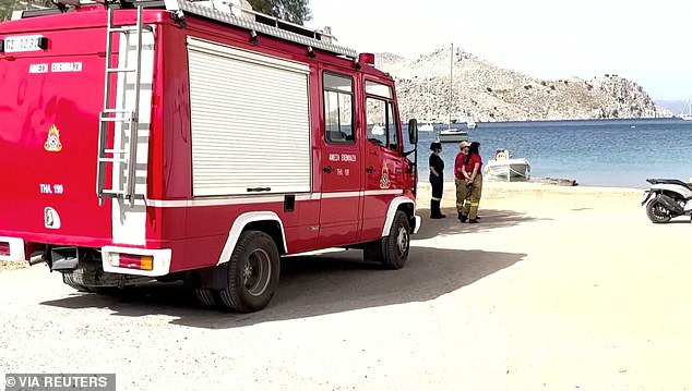 Firefighters on a beach during a search for Dr Mosley yesterday on the Greek island of Symi