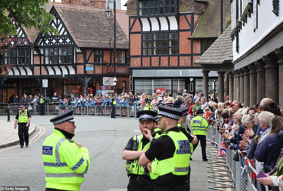 A general view of police and well-wishers as they line the street near the cathedral