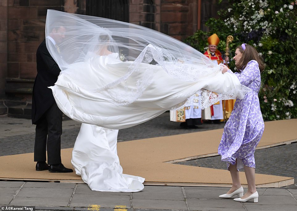 The veil blew strongly in the wind, prompting gasps from the crowd, as she entered the cathedral