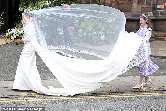 The veil blew in the wind, prompting gasps from the crowd, as the bride entered the cathedral