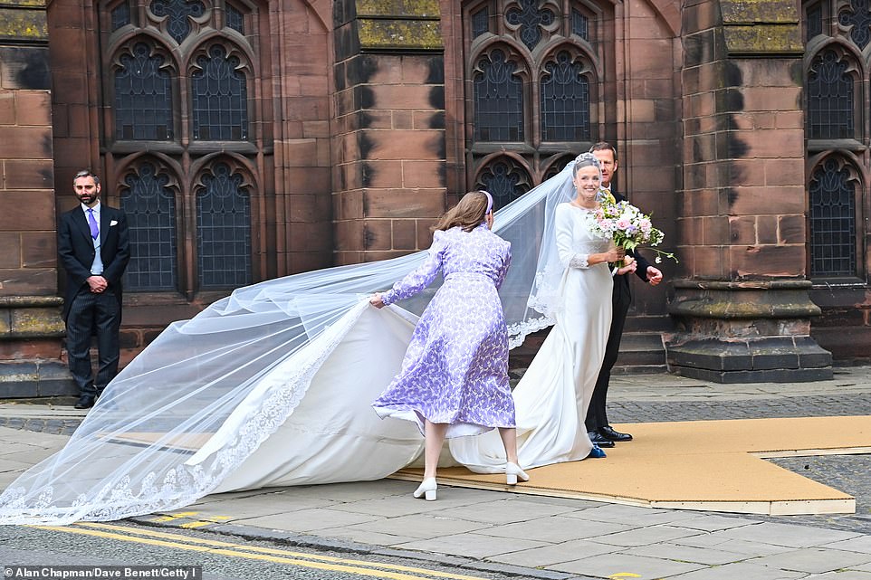 The bridge smiled in her wedding dress before walking into the Cathedral to marry the Duke of Westminster