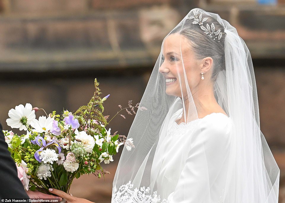 Olivia looks elated as she arrives at her wedding to the Duke of Westminster in Cheshire