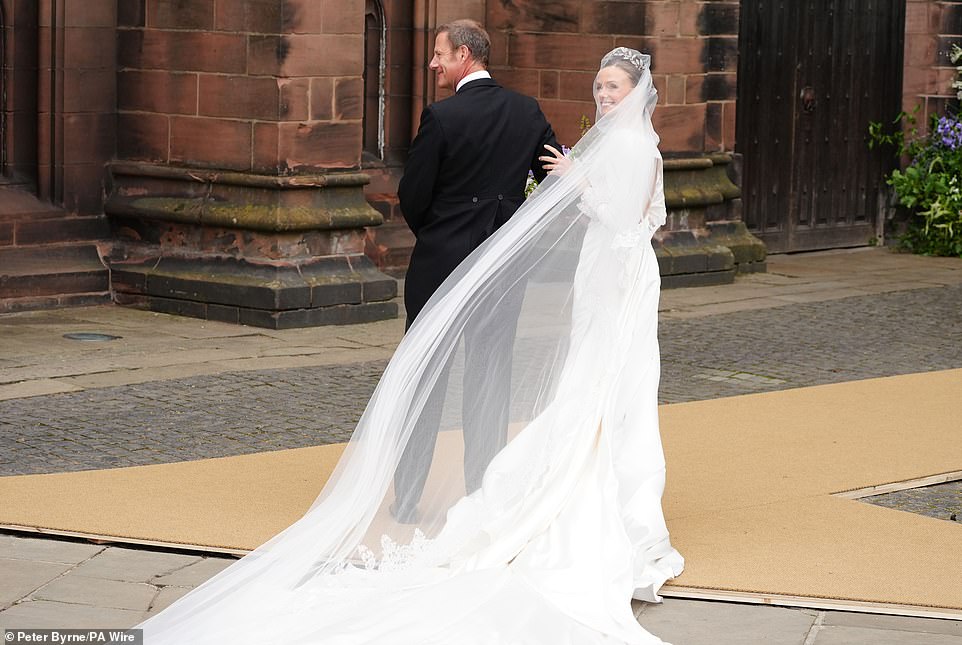 Olivia stops and smiles at the crowds before heading inside the Cathedral to marry the Duke of Westminster