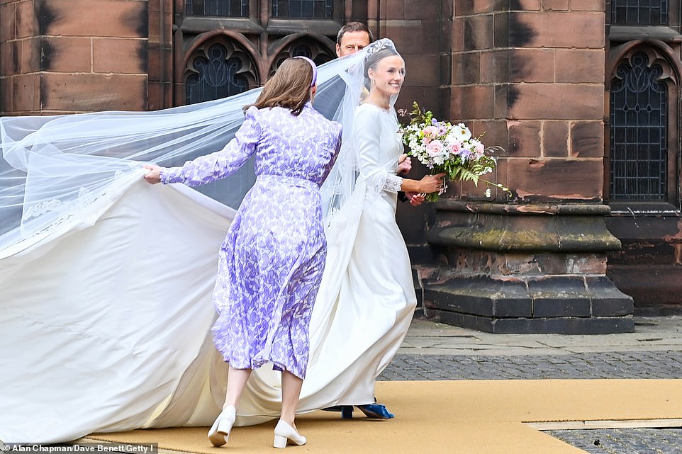Olivia opted to make her shoes the 'something blue' at her wedding, which she paired with pink and purple flowers