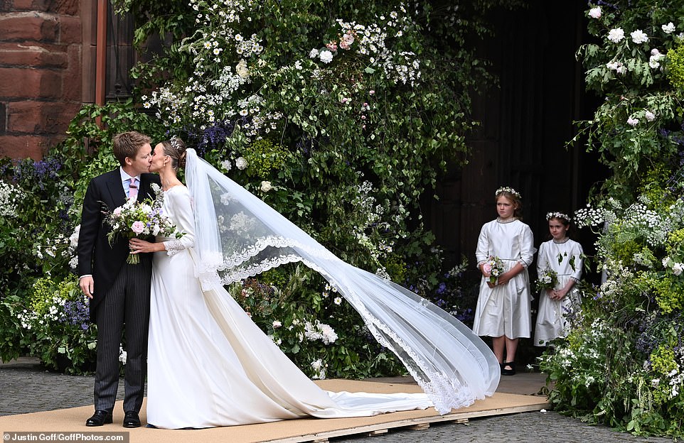 A kiss for the billionaire bride and groom! Duke of Westminster and Olivia Henson are married after society wedding of the year at Chester Cathedral with Prince William as usher and Princess Eugenie among glittering array of aristocratic guests