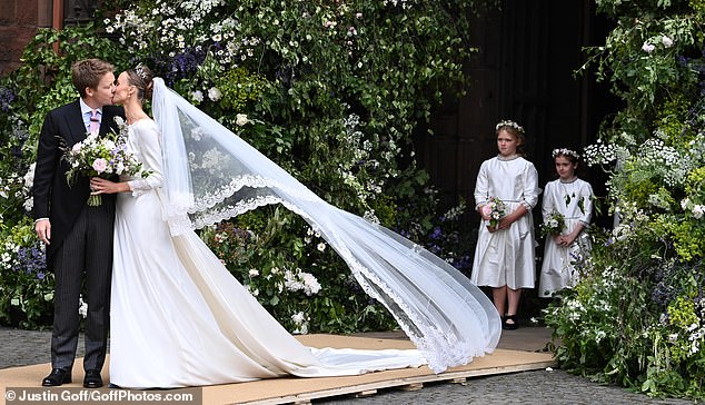 A kiss for the bride! The coupe share a sweet peck after their wedding ceremony today