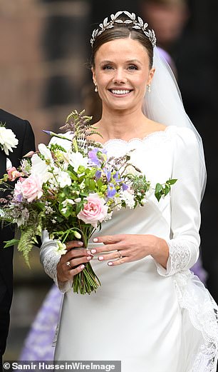 The bride's dazzling tiara featured leaf detailing, while her hair was styled into an elegant up-do