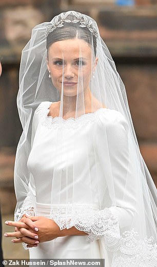 The bride's dazzling tiara featured leaf detailing, while her hair was styled into an elegant up-do