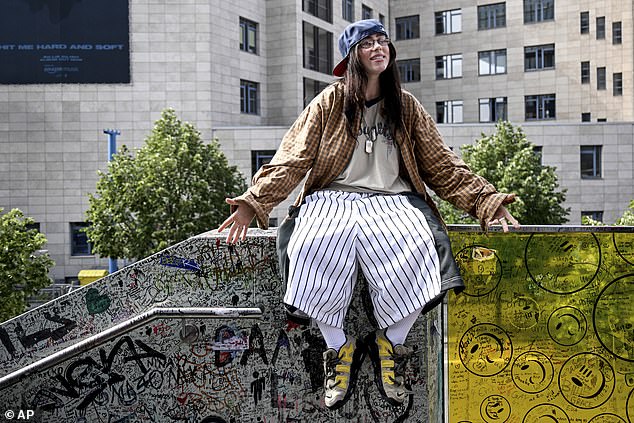 Billie Eilish shows off her quirky sense of style in striped oversized baseball shorts and a baseball cap in Berlin