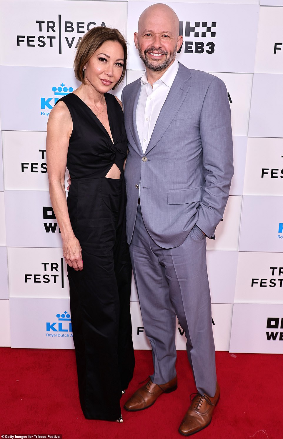 John looked like a dapper guy at the premiere wearing a silver suit without a tie, he posed with his wife Lisa Joyner who was dressed in black