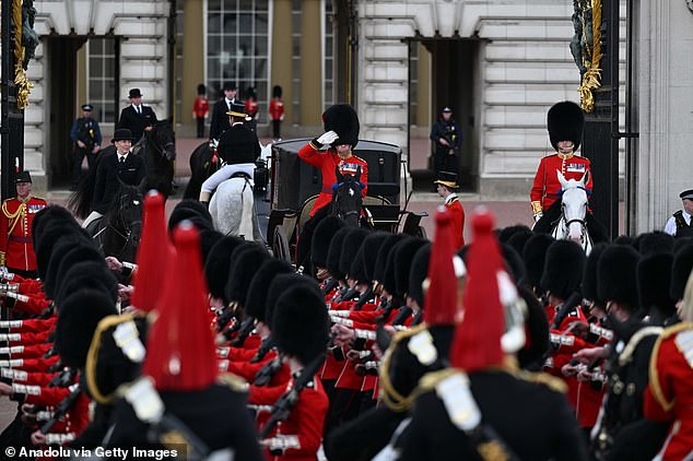 A guard is pictured saluting at the Colonel's Review parade on June 8 which is part of the Trooping the Colour ceremony