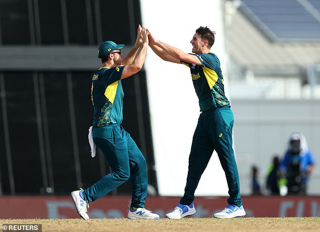 Pat Cummins and Mitchell Marsh celebrate after taking the wicket of England's Moeen Ali