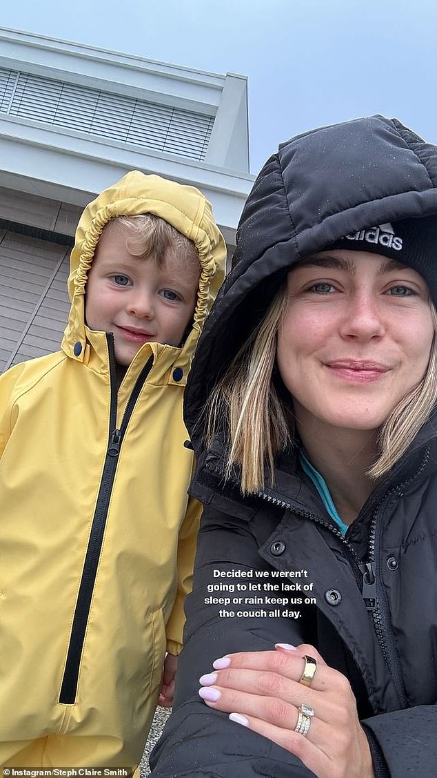 The blonde woman later posted a smiley photo on Instagram of herself and Harvey going for a walk outside while wearing raincoats.