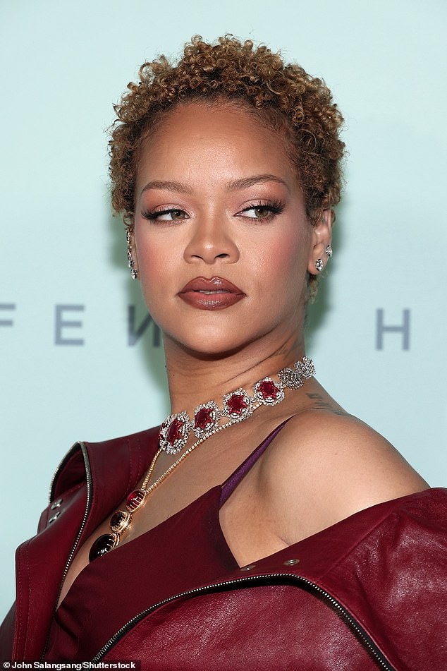 Rihanna added more attention to her look with a silver necklace adorned with red gems and a matching pendant