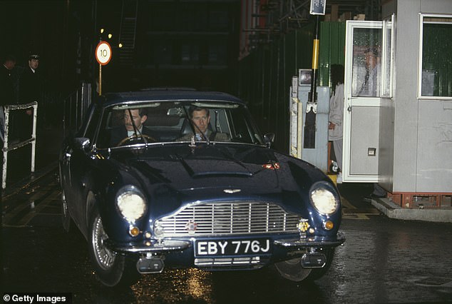 Prince Charles arrives at Great Ormond Street Hospital in his vintage blue Aston Martin car