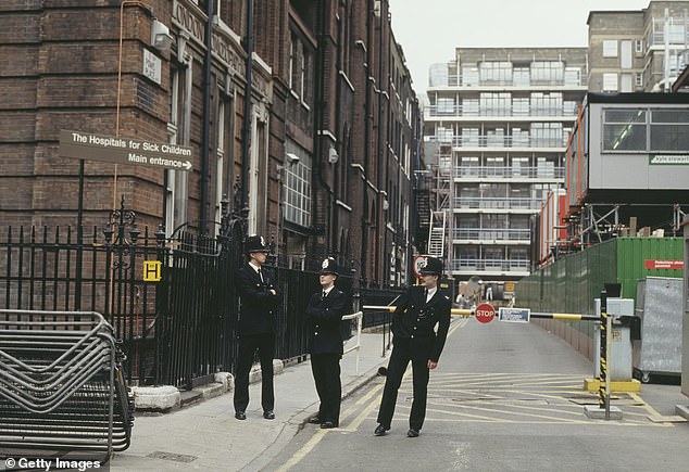 Police officers pictured at Powis Place, near Great Ormond Street Hospital in London