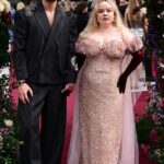 Nicola Coughlan steals the show in sequinned pink gown as she holds hands with her dapper onscreen lover Luke Newton at Bridgerton’s Season Three Part II premiere in London