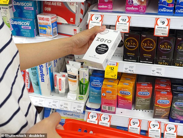 The pharmacy's co-owner said the store did not sell all contraceptive items, including condoms (pictured, a shopper choosing condoms in the healthcare aisle at Coles)