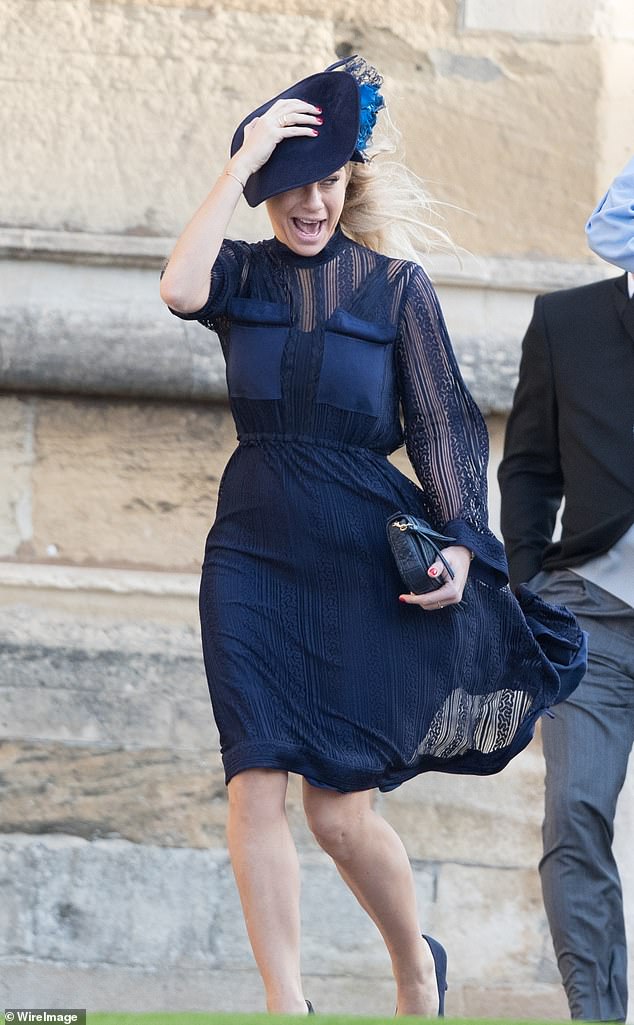 Chelsy Davy screams in strong wind as she arrives at St George's Chapel for Princess Eugenie and Jack Brooksbank's wedding