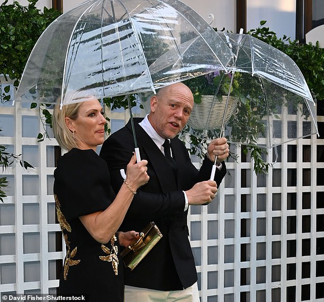 The couple was protected from the summer rain with the help of giant umbrellas