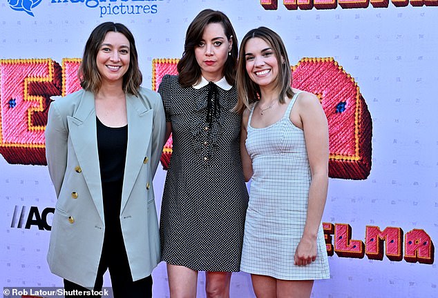Aubrey brought along her sister Natalie Plaza (left), who wore a short blue plaid dress