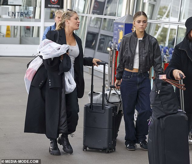 Natalie Bassingthwaighte looks effortlessly stylish as she chats to her mini-me daughter Harper at Sydney Airport