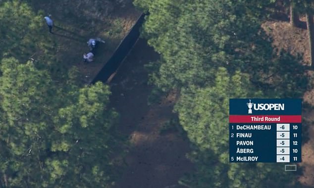 Bizarre moment US Open leader Bryson Dechambeau sneaks into the woods to get stretched out by his trainer… and then immediately hits the longest drive of the day!