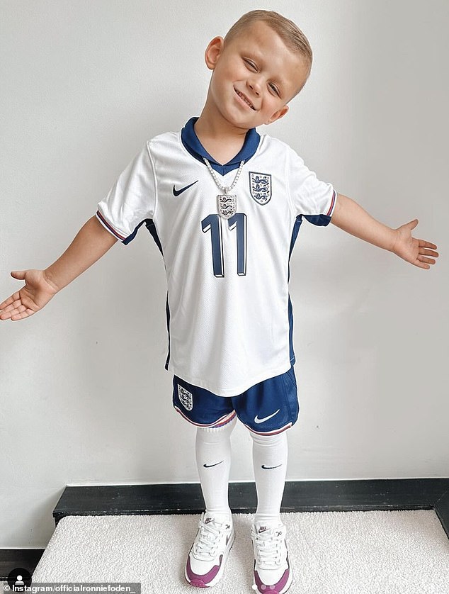 Phil Foden's son, Ronnie Foden (pictured), looked adorable wearing the full England kit and matching chain
