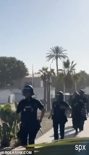 Stunned Erling Haaland is asked for ID by armed police as footage emerges of balaclava-clad security raiding his favourite beach club in Marbella… a week after he was pictured at the venue living it up in a £2,500 silk Louis Vuitton outfit