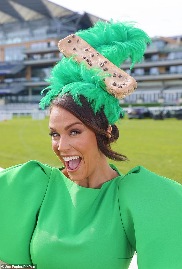 The TV personality completed her stylish green outfit with a quirky green fascinator which had a giant cookie attached to it