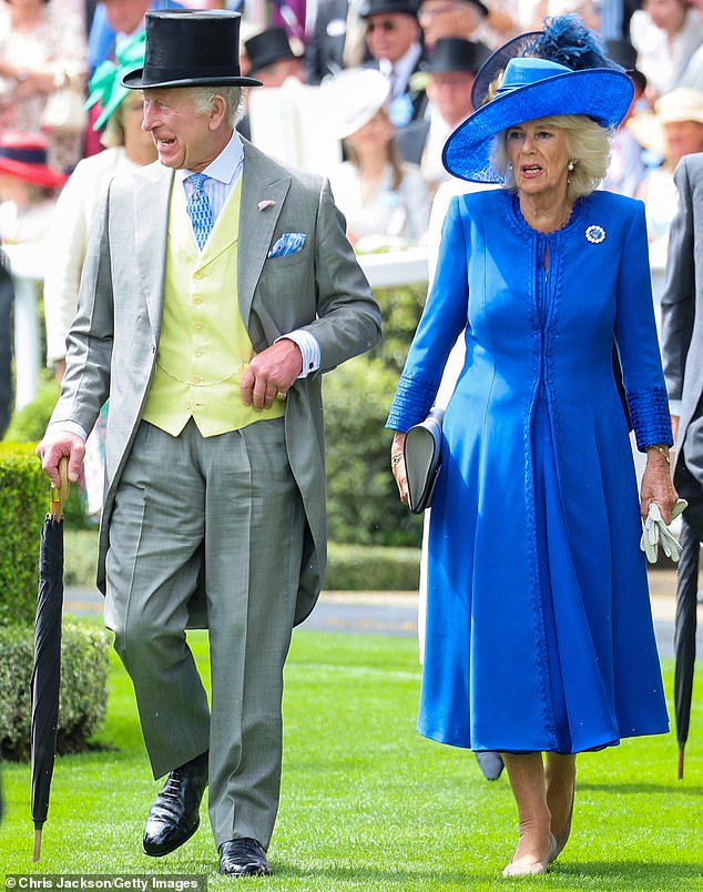 King Charles appears in good spirits as he beams at people while making his way across the event with Queen Camilla