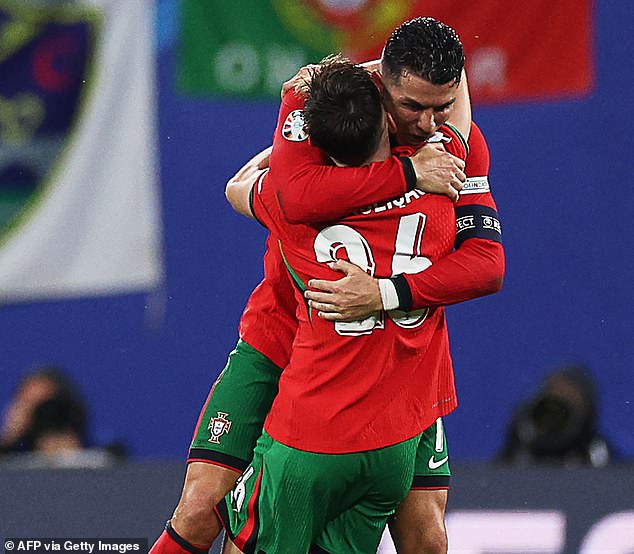 Ronaldo hugs Francisco Conceicao after scoring the winning goal in the 92nd minute