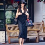 Anne Hathaway looks chic in a waistcoat and straw hat as she runs errands in New York City