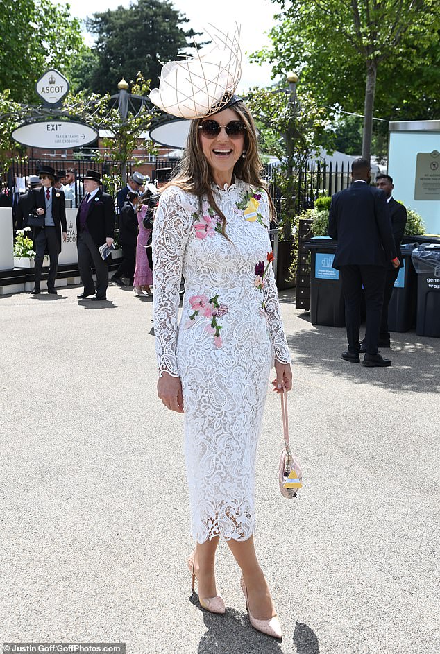 Liz showcased her slender figure in the form-fitting midi dress which was adorned with floral embroidery