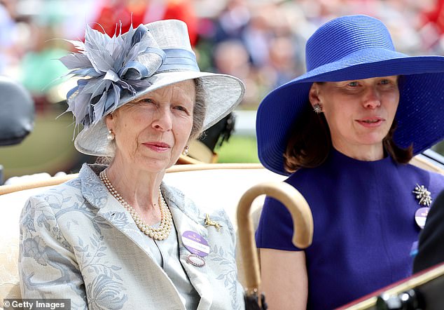 Sarah arrived on the third day of the annual races with Princess Anne (left), who wore a striking blue and silver suit and a floral hat in matching colours.
