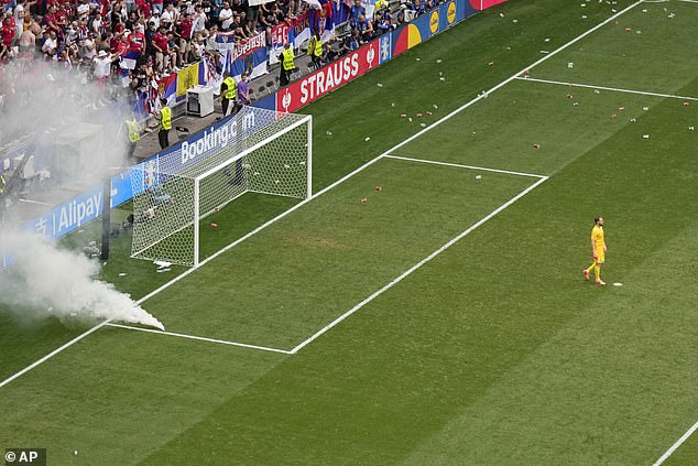 A smoke bomb was thrown onto the playing field after Oblak urged fans to stop throwing cups