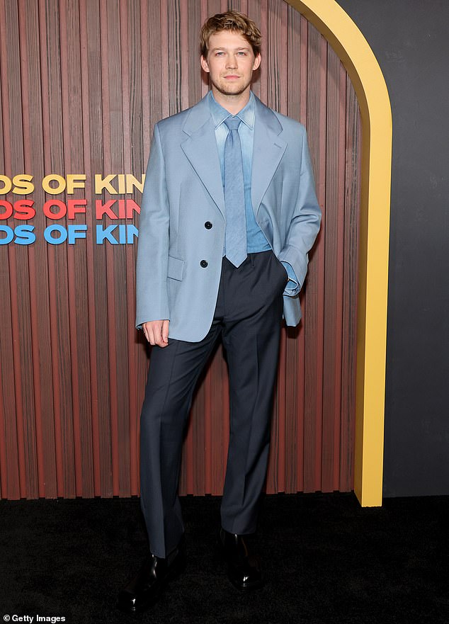 Joe Alwyn - who recently broke his silence over his split with Taylor Swift - was dapper in a pair of dark gray trousers as well as a light blue, dress shirt
