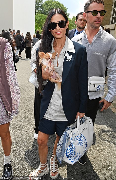 Demi added to her look with culottes and slipped her feet into white gladiator sandals. Demi accessorised with a large white Dior handbag and a patterned blue scarf