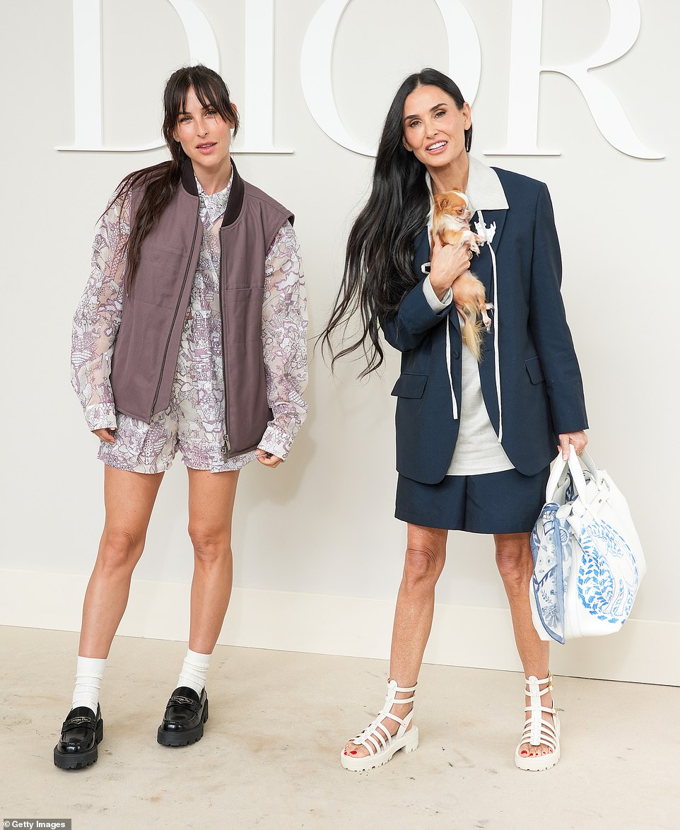 Nailing androgynous dressing was Demi, 61, (right) who opted for an oversized navy blazer layered over a grey blouse with large lapels