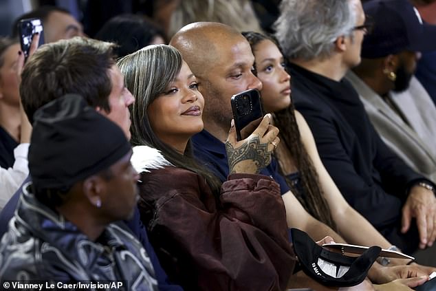 The singer looked quite happy as she sat in the front row and recorded some pictures of the event on her phone.