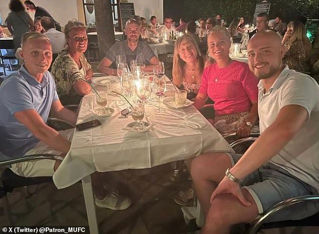 Ten Hag (third from left) was on holiday when club officials arrived to ask him to stay.